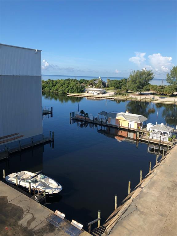 100 Circuit Road, Unit N77 Nokomis, FL 34275 - Photo 4 of 12 a view of a lake with a table and chairs on the roof deck