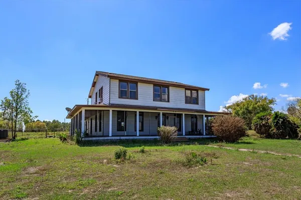 a view of a house with a yard and garage