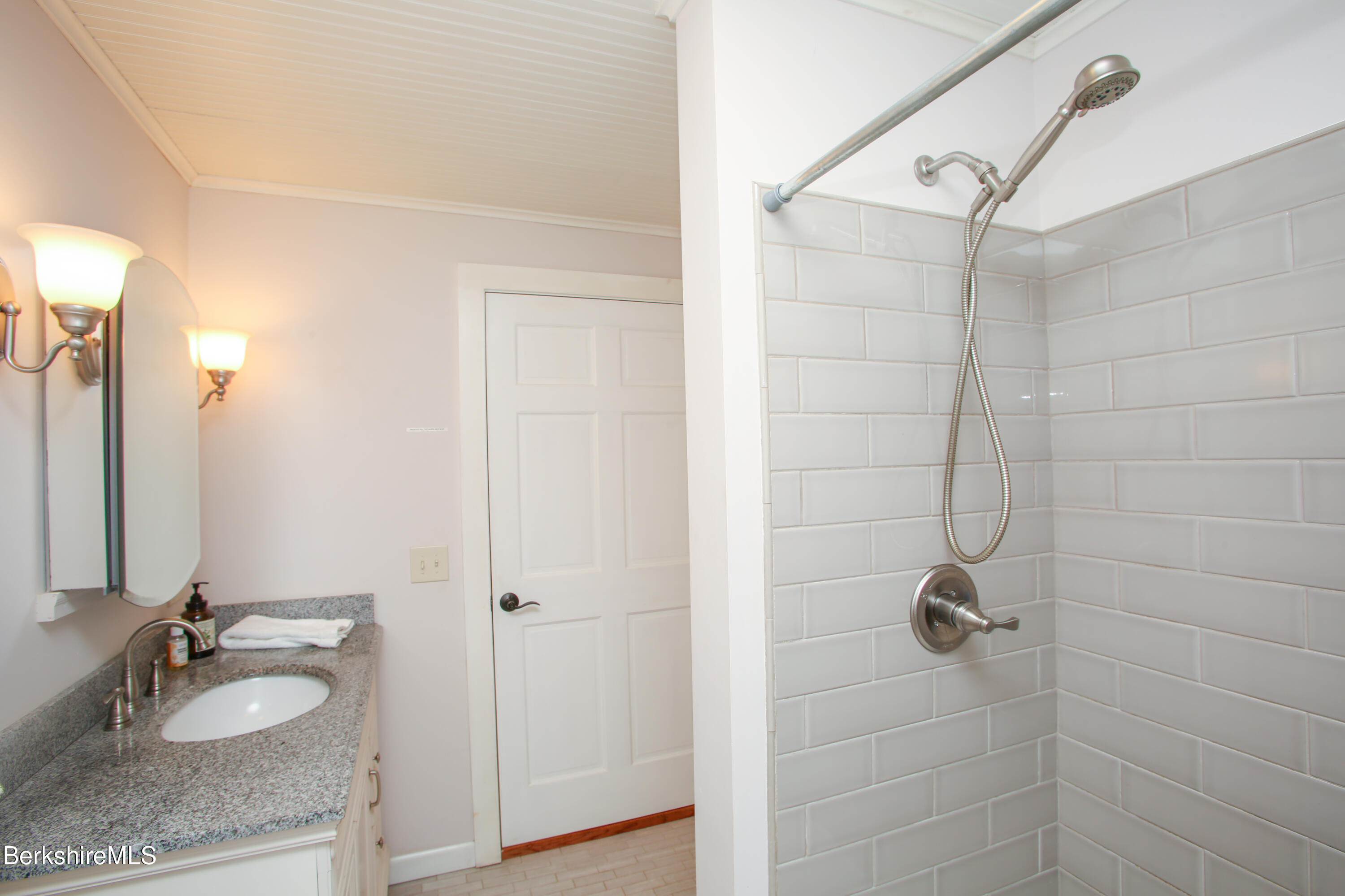 127 County Road Rowe, MA 01367 - Photo 19 of 29 a bathroom with a granite countertop sink a mirror and shower