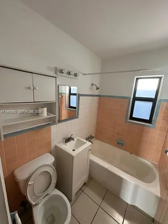 a bathroom with a sink a toilet and bathtub