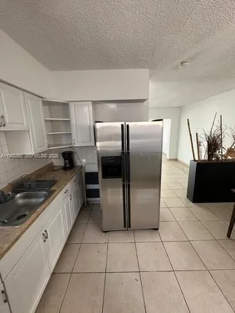 a kitchen with stainless steel appliances a refrigerator sink and microwave