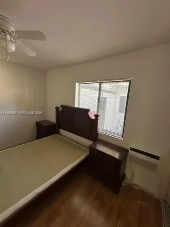 a bed sitting in a room next to a window