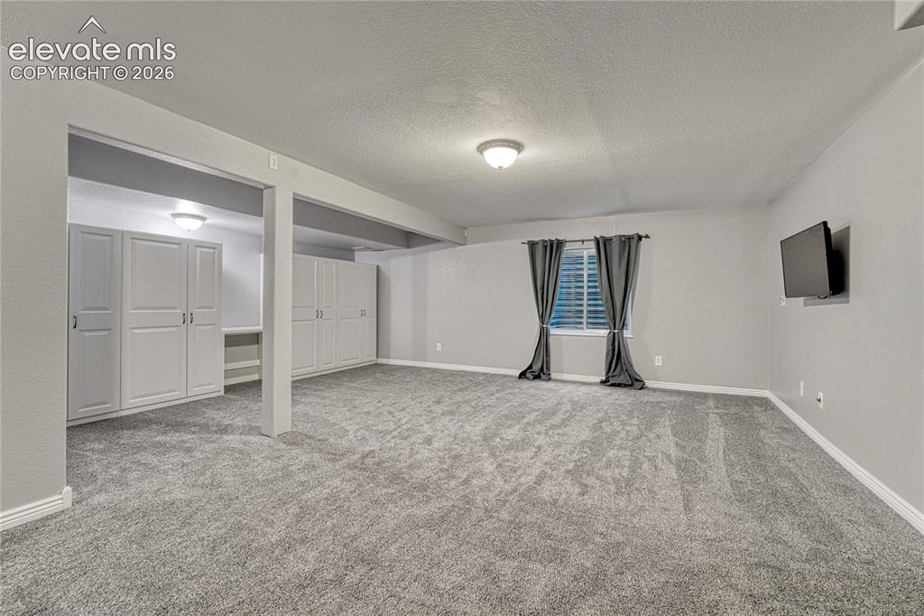 13695 Woodlake Road Elbert, CO 80106 - Photo 27 of 39 Large family and recreation room has great built-in storage and is pre-plumbed for a wet bar.