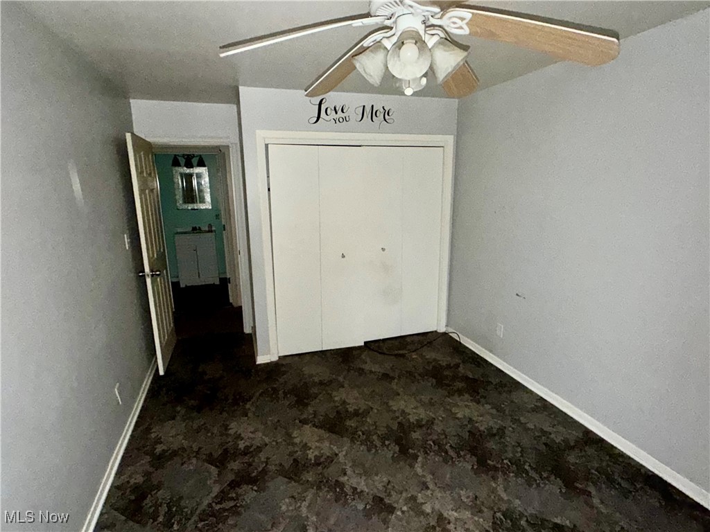 2898 Canton Road Uniontown, OH 44685 - Photo 19 of 20 Unfurnished bedroom featuring a closet and a ceiling fan