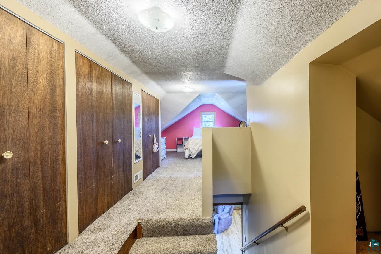 2581 O'Rourke Road Hibbing, MN 55746 - Photo 17 of 61 Carpeted upper level featuring a dormer window, wood-finish closet doors, and recessed lighting