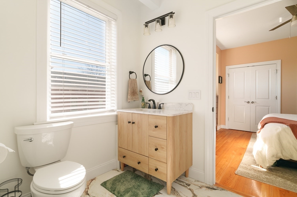 412 Meridian Street, Unit 3 Boston, MA 02128 - Photo 15 of 30 a bathroom with a toilet a sink and a mirror