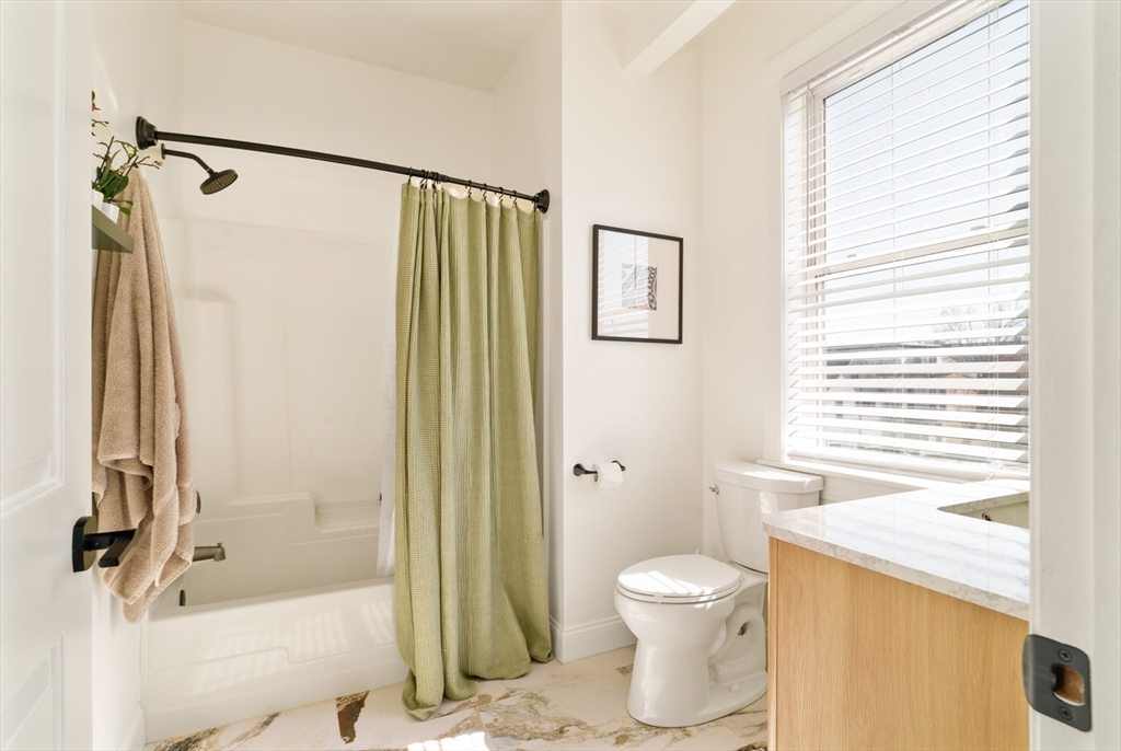 412 Meridian Street, Unit 3 Boston, MA 02128 - Photo 16 of 30 a bathroom with a granite countertop shower a toilet and a sink