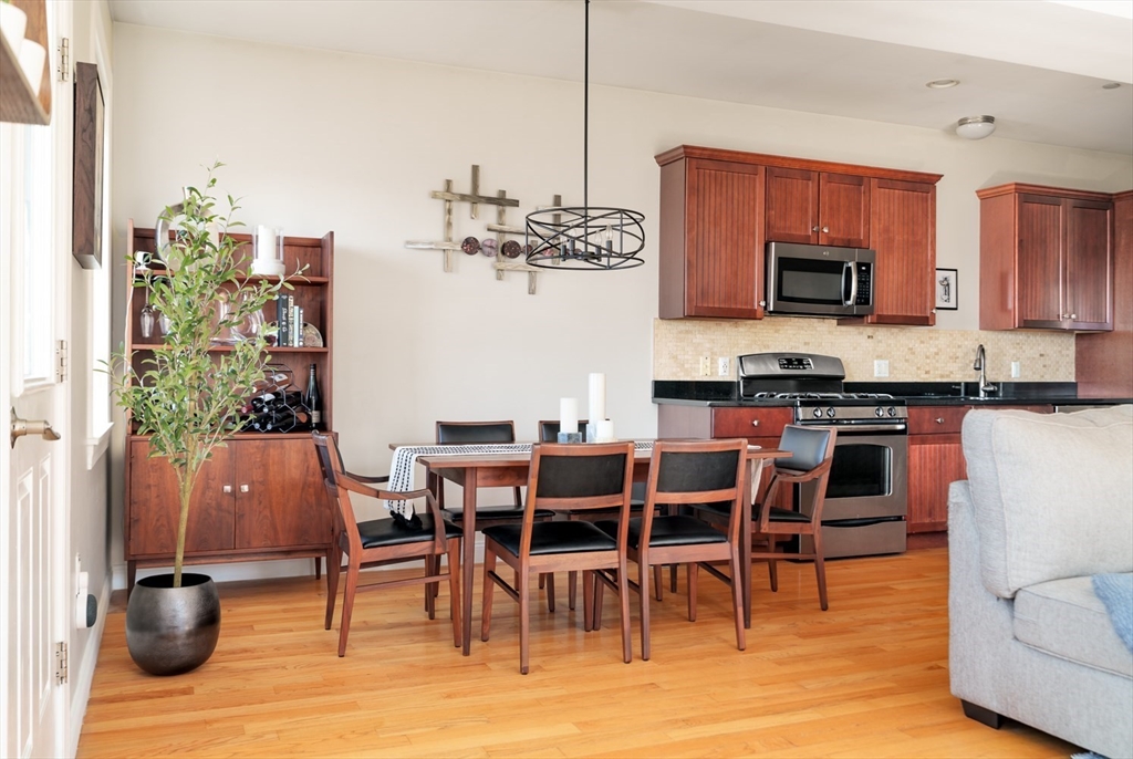 412 Meridian Street, Unit 3 Boston, MA 02128 - Photo 4 of 30 a dining table with chairs and kitchen view