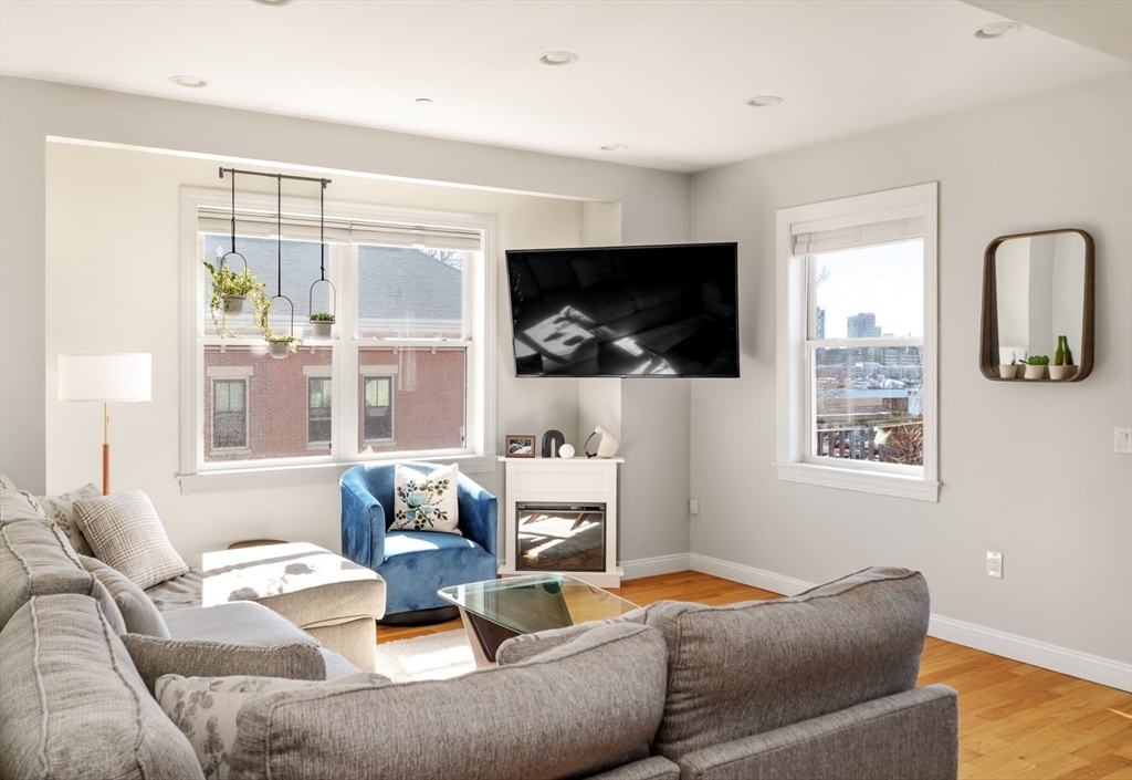 412 Meridian Street, Unit 3 Boston, MA 02128 - Photo 7 of 30 a living room with furniture and a flat screen tv