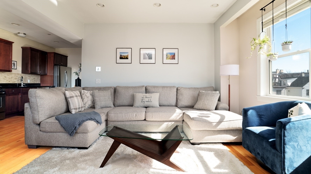 412 Meridian Street, Unit 3 Boston, MA 02128 - Photo 10 of 30 a living room with furniture and a large window