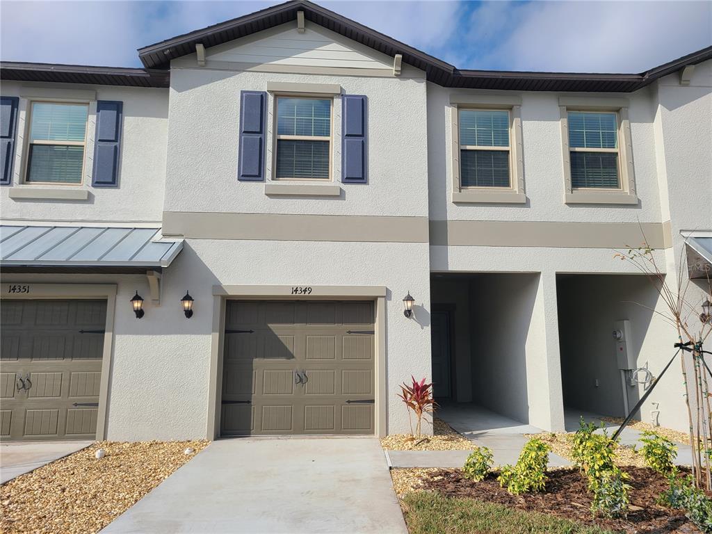 14349 Editors Note Street Ruskin, FL 33573 - Photo 1 of 20 a front view of a house