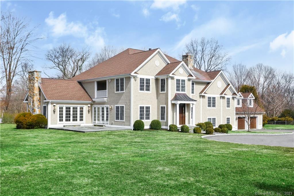10 Highview Drive Wilton, CT 06897 - Photo 1 of 1 a front view of a house with a garden