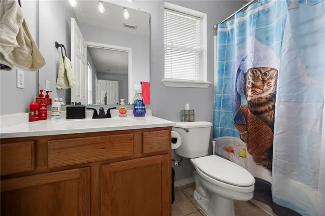 a bathroom with a sink toilet vanity and window