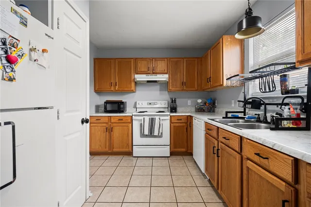 a kitchen with a stove top oven sink and cabinets