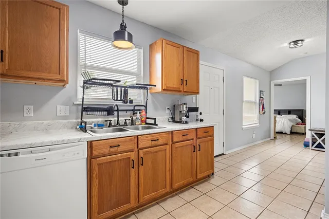 a kitchen with sink cabinets and window