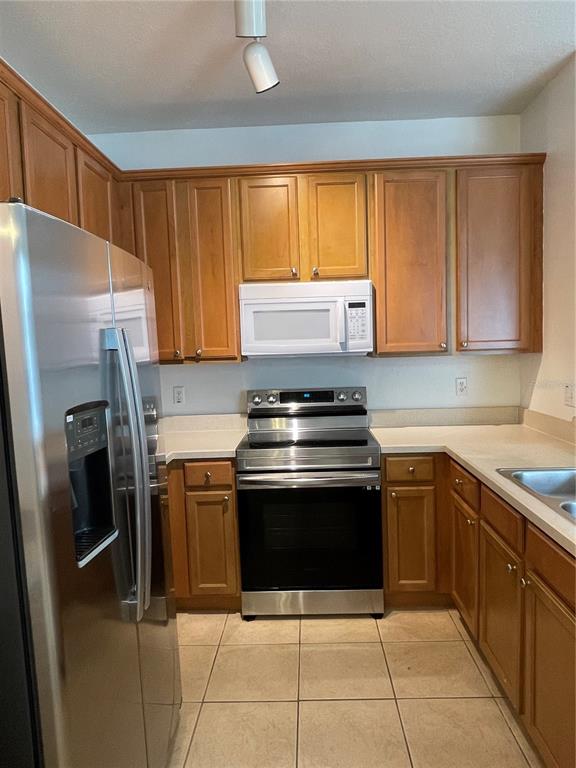 4282 Morton Court Lakeland, FL 33813 - Photo 19 of 72 a kitchen with a stove sink and refrigerator
