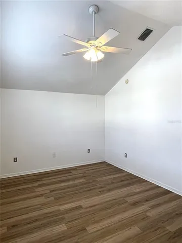 a view of a room with wooden floor and staircase