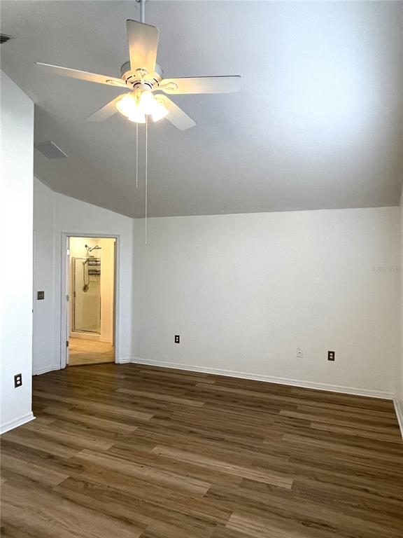 4282 Morton Court Lakeland, FL 33813 - Photo 27 of 72 a view of an empty room with wooden floor and a chandelier