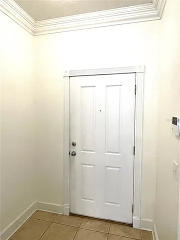 a view of an empty room and chandelier fan