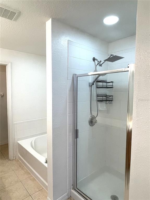 4282 Morton Court Lakeland, FL 33813 - Photo 32 of 72 a bathroom with a bathtub and a shower