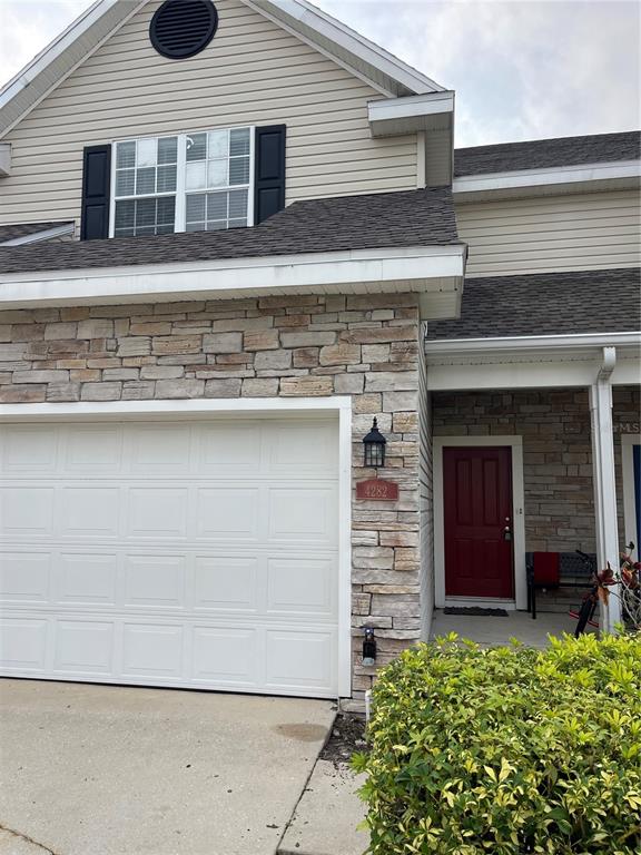 4282 Morton Court Lakeland, FL 33813 - Photo 61 of 72 a front view of a house with a garden and plants