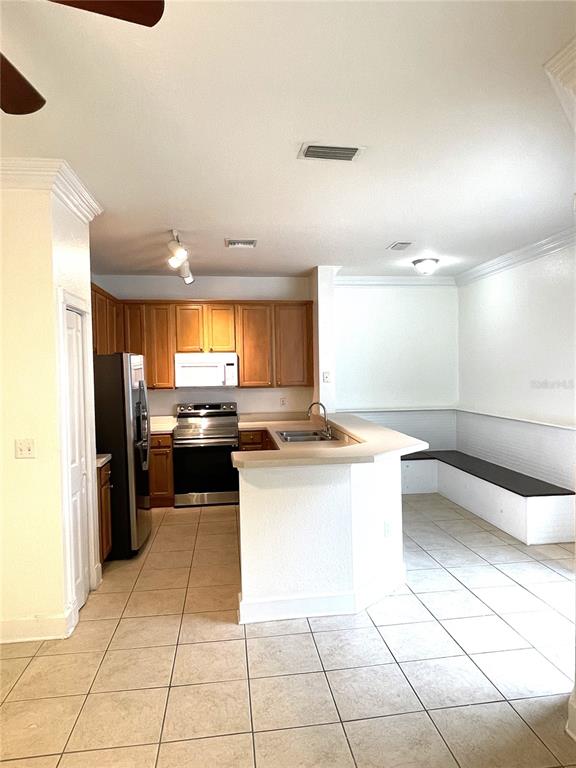 4282 Morton Court Lakeland, FL 33813 - Photo 9 of 72 a kitchen with a sink a stove top oven and cabinets