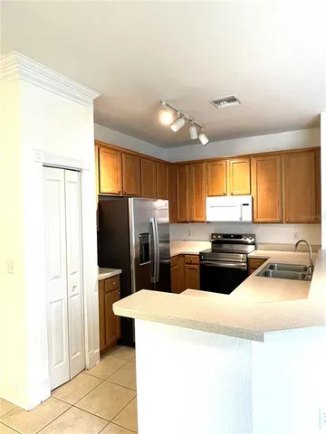 a kitchen with a stove sink and refrigerator