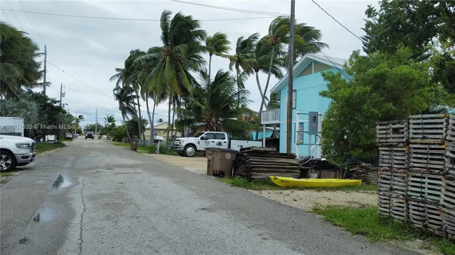 a view of a street with potted plants