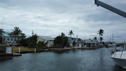 a view of a lake with boats and trees