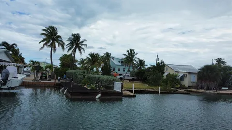 a view of a house with swimming pool and sitting area