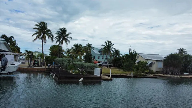 a view of a house with swimming pool and sitting area