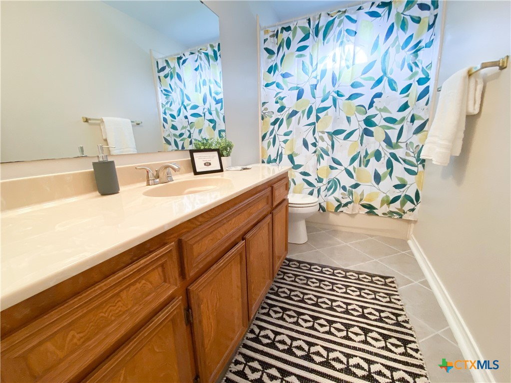 2703 Larkspur Drive Killeen, TX 76549 - Photo 15 of 17 a bathroom with a sink and a mirror