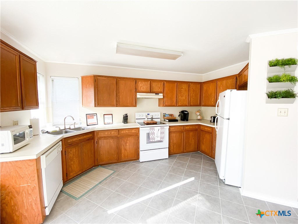 2703 Larkspur Drive Killeen, TX 76549 - Photo 8 of 17 a large kitchen with a cabinets a sink a window and stainless steel appliances
