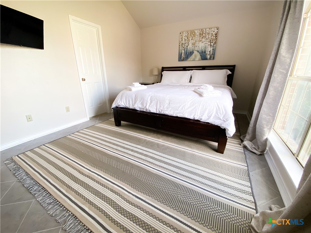 2703 Larkspur Drive Killeen, TX 76549 - Photo 10 of 17 a bedroom with a bed and a flat screen tv
