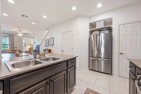 a kitchen with kitchen island a sink and refrigerator