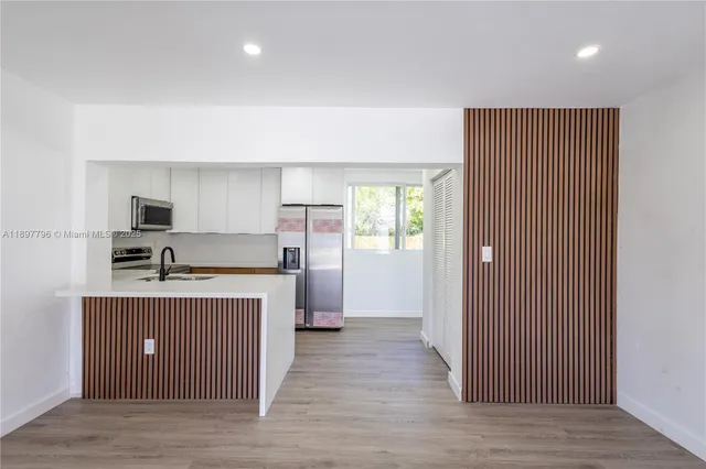 a kitchen with stainless steel appliances a sink stove and refrigerator