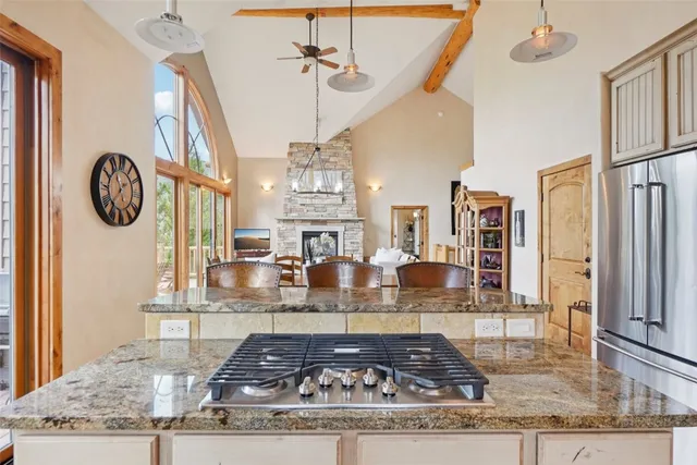 a kitchen with a stove a sink and a wooden cabinets