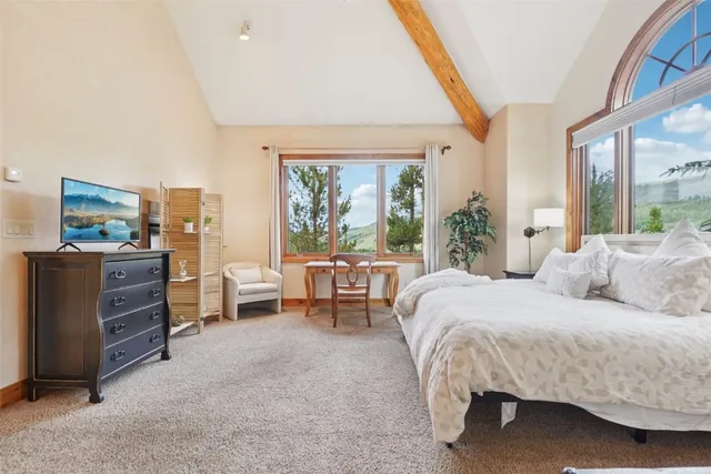 a bedroom with a bed and a large window