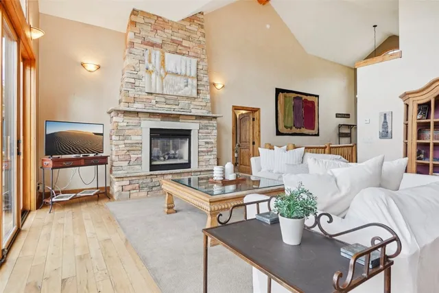 a living room with furniture a fireplace and a large window