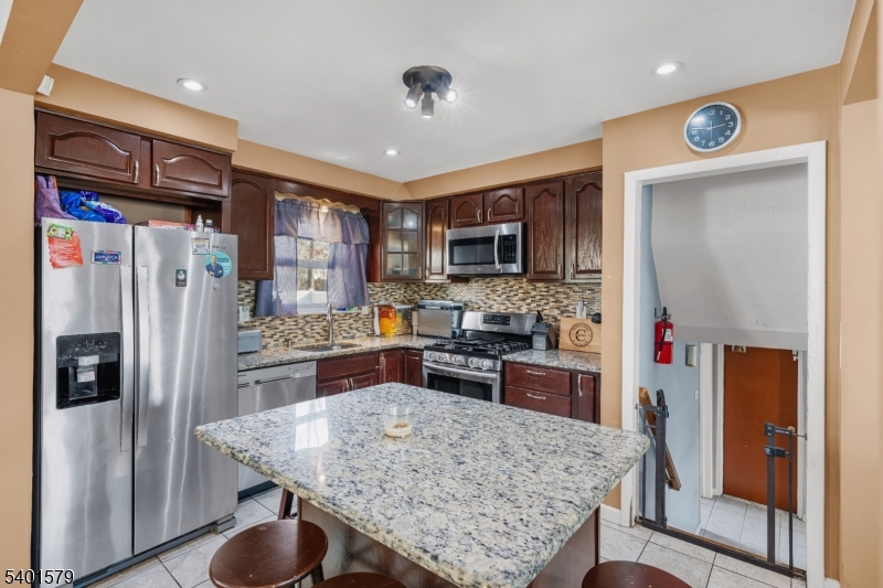 2563 Jackson Avenue Union, NJ 07083 - Photo 13 of 39 a kitchen with stainless steel appliances granite countertop a refrigerator stove microwave and sink