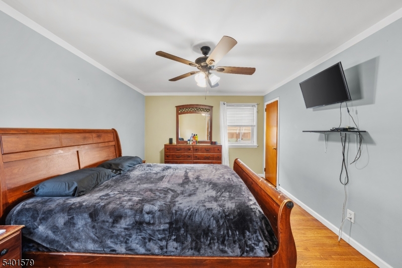 2563 Jackson Avenue Union, NJ 07083 - Photo 17 of 39 a bed room with a bed window and a flat screen tv