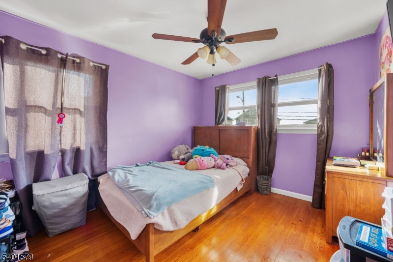 2563 Jackson Avenue Union, NJ 07083 - Photo 20 of 39 a bedroom with a bed and a chandelier