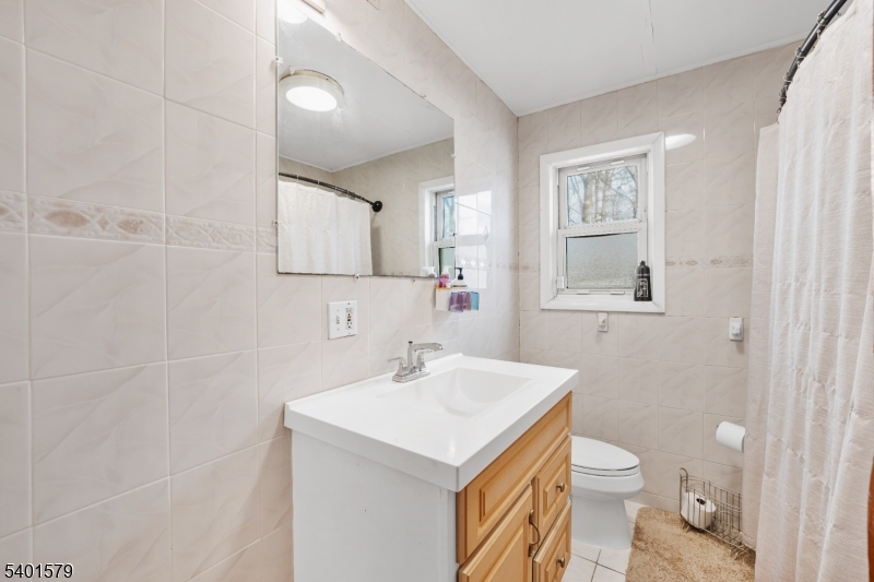 2563 Jackson Avenue Union, NJ 07083 - Photo 24 of 39 a bathroom with a sink toilet and mirror