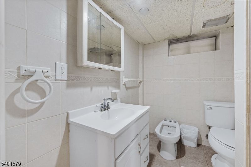 2563 Jackson Avenue Union, NJ 07083 - Photo 26 of 39 a bathroom with a toilet sink and mirror