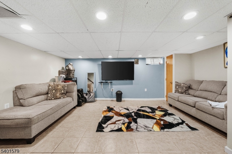 2563 Jackson Avenue Union, NJ 07083 - Photo 30 of 39 a living room with furniture a flat screen tv and a couch