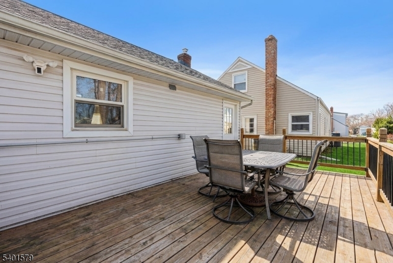 2563 Jackson Avenue Union, NJ 07083 - Photo 37 of 39 a view of a deck with table and chairs with wooden floor and fence