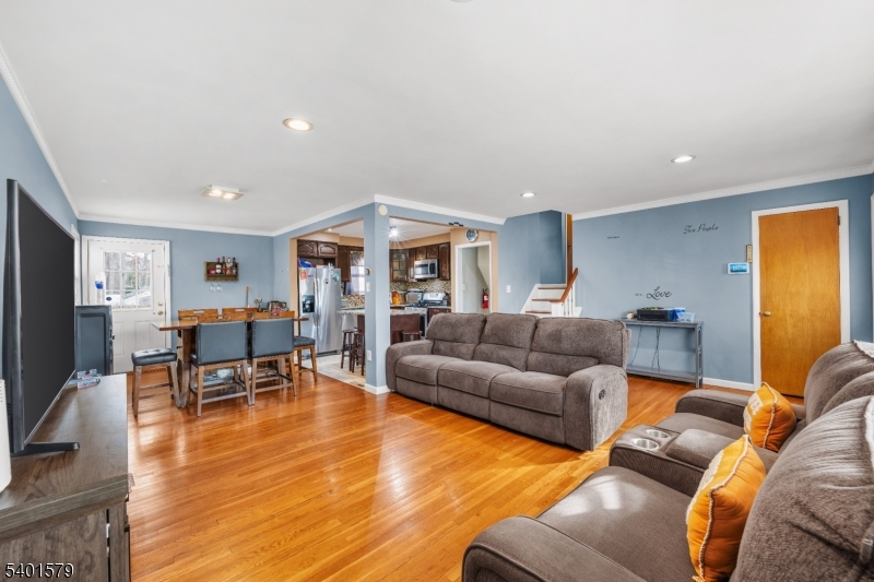 2563 Jackson Avenue Union, NJ 07083 - Photo 8 of 39 a living room with furniture wooden floor and a flat screen tv