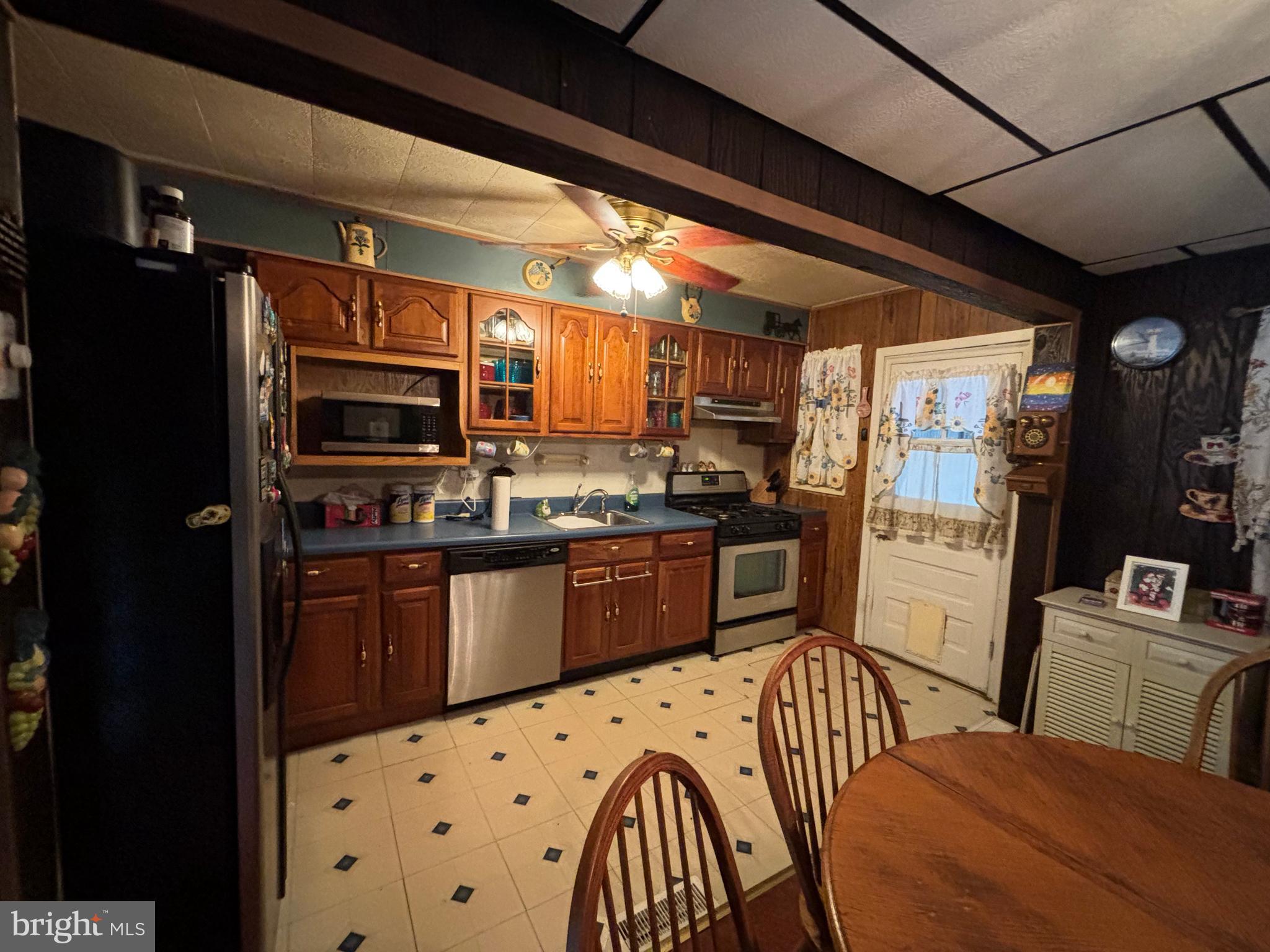 7552 Rabon Avenue Baltimore, MD 21222 - Photo 11 of 39 a kitchen with stainless steel appliances kitchen island granite countertop a refrigerator a stove top oven a sink and dishwasher