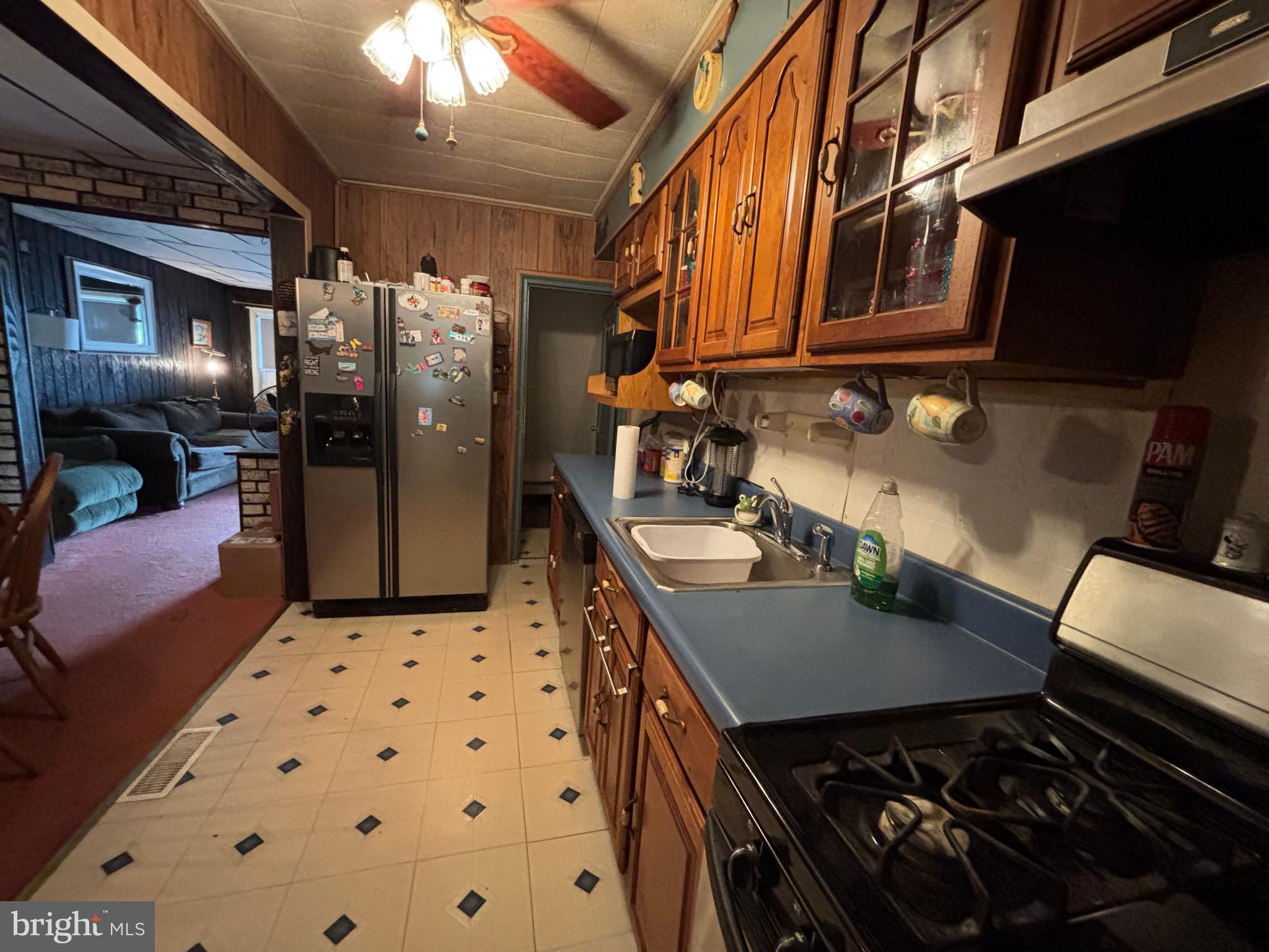 7552 Rabon Avenue Baltimore, MD 21222 - Photo 12 of 39 a kitchen with stainless steel appliances granite countertop a stove a sink and a refrigerator