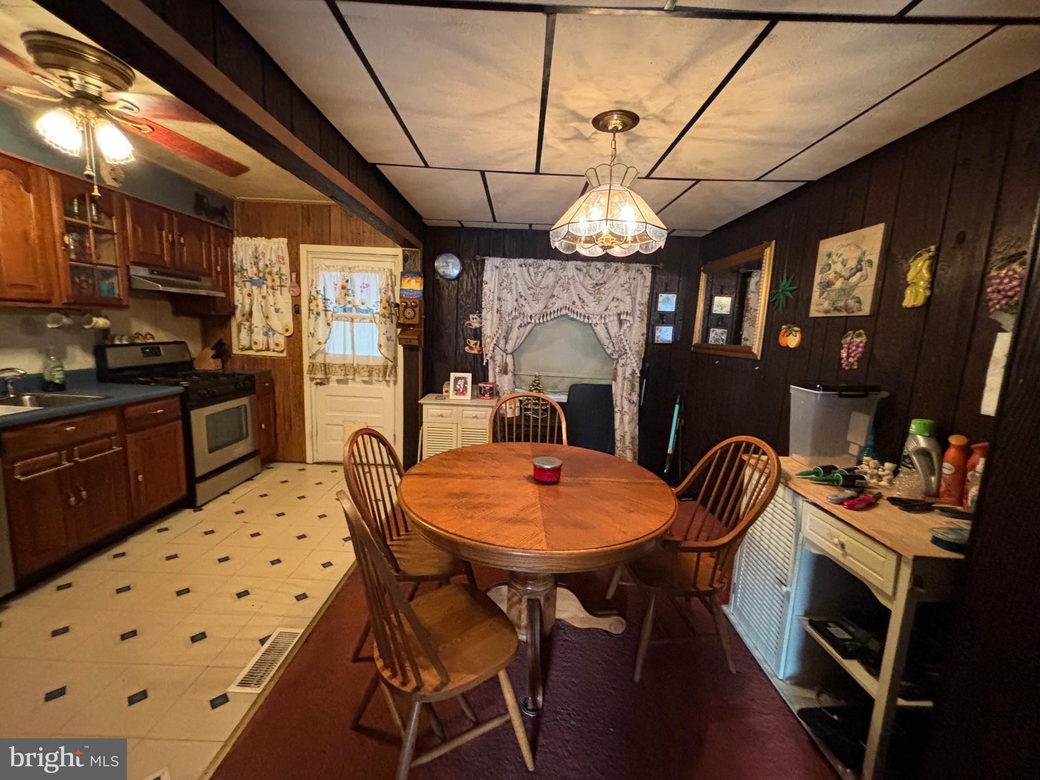 7552 Rabon Avenue Baltimore, MD 21222 - Photo 9 of 39 a view of a dining room with furniture window and wooden floor